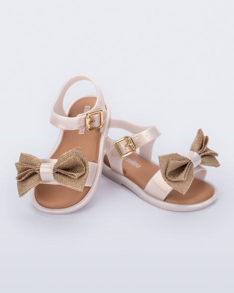 Angled view of a pair of pearly beige Mar Sweet baby sandals