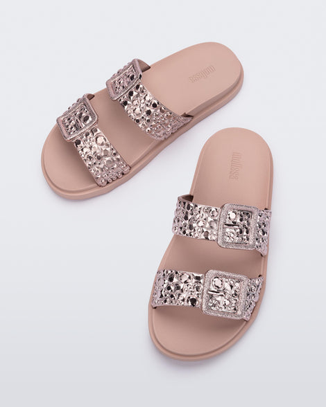 Top view of a pair of pink Lust Slide with metallic buckle straps