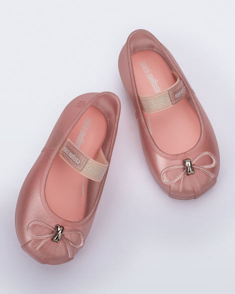 Top view of a pair of pearly pink Sophie baby ballerina flats with bow