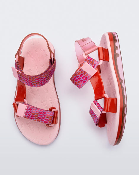 Side and top view of a pair of pink Melissa Papete sandals with patterned pink, pink and red straps.