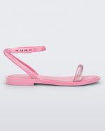 Side view of a pink Melissa Wave Sandal with a clear pink front strap and a pink ankle strap and sole.