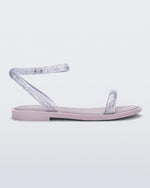 Side view of a lilac/clear glitter Melissa Wave Sandal with a lilac base and a clear glitter front and ankle straps.