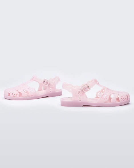 outer side view of a pair of Melissa Possession fisherman sandals in pink with cut out lace detail on the straps.