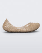 Side view of a Beige/Glitter Mini Melissa Campana flat with a woven detail base.