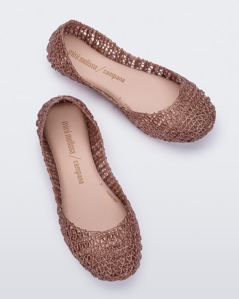 Top view of a pair of light pink glitter Mini Melissa Campana flats with an open woven texture.