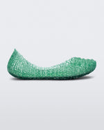 Side view of a green Mini Melissa Campana flat with an open woven texture.