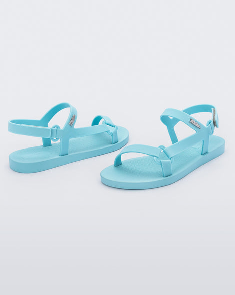 Angled view of a pair of Melissa Sun Downtown sandasl with light blue front cross and back ankle straps.