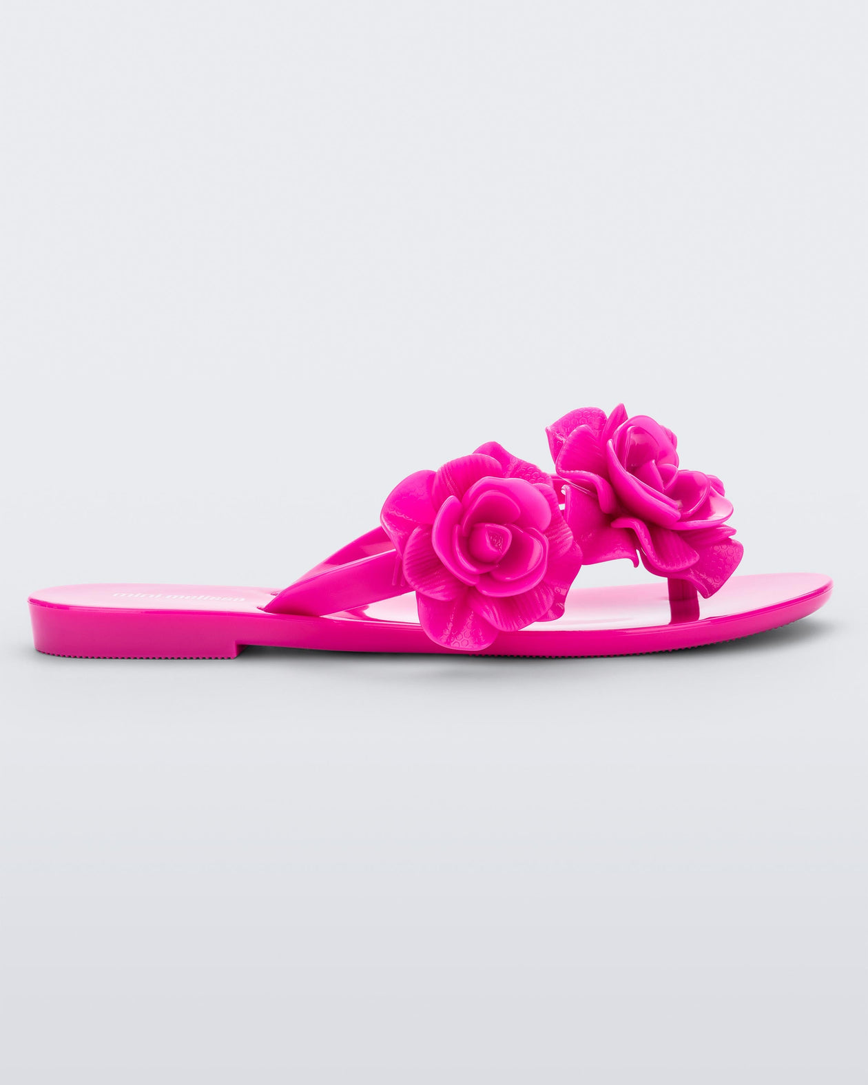 Side view of a pink Melissa Harmonic Garden flip flop with flowers on the straps.