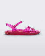 Side view of a pink Melissa Real Jelly Sandal sandal with two front straps and an ankle strap.