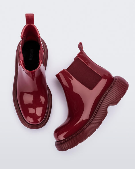 Top and side view of a pair of Melissa Step slip on ankle boots in Red with stretch side detail and lugg sole 