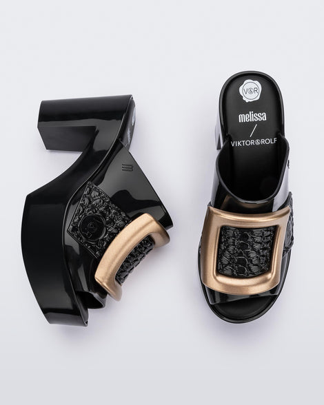 Top and side view of a pair of black Melissa's Buckle Up heeld mules with a gold buckle.