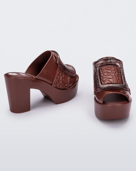 Angled view of a pair of brown Meilssa Buckle Up platform heeled mules.