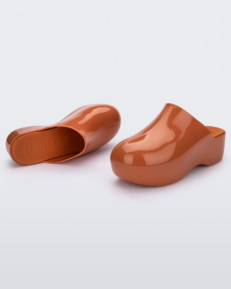 Angled view of a pair of brown Melissa Bubble clogs from the Simon Miller collaboration.