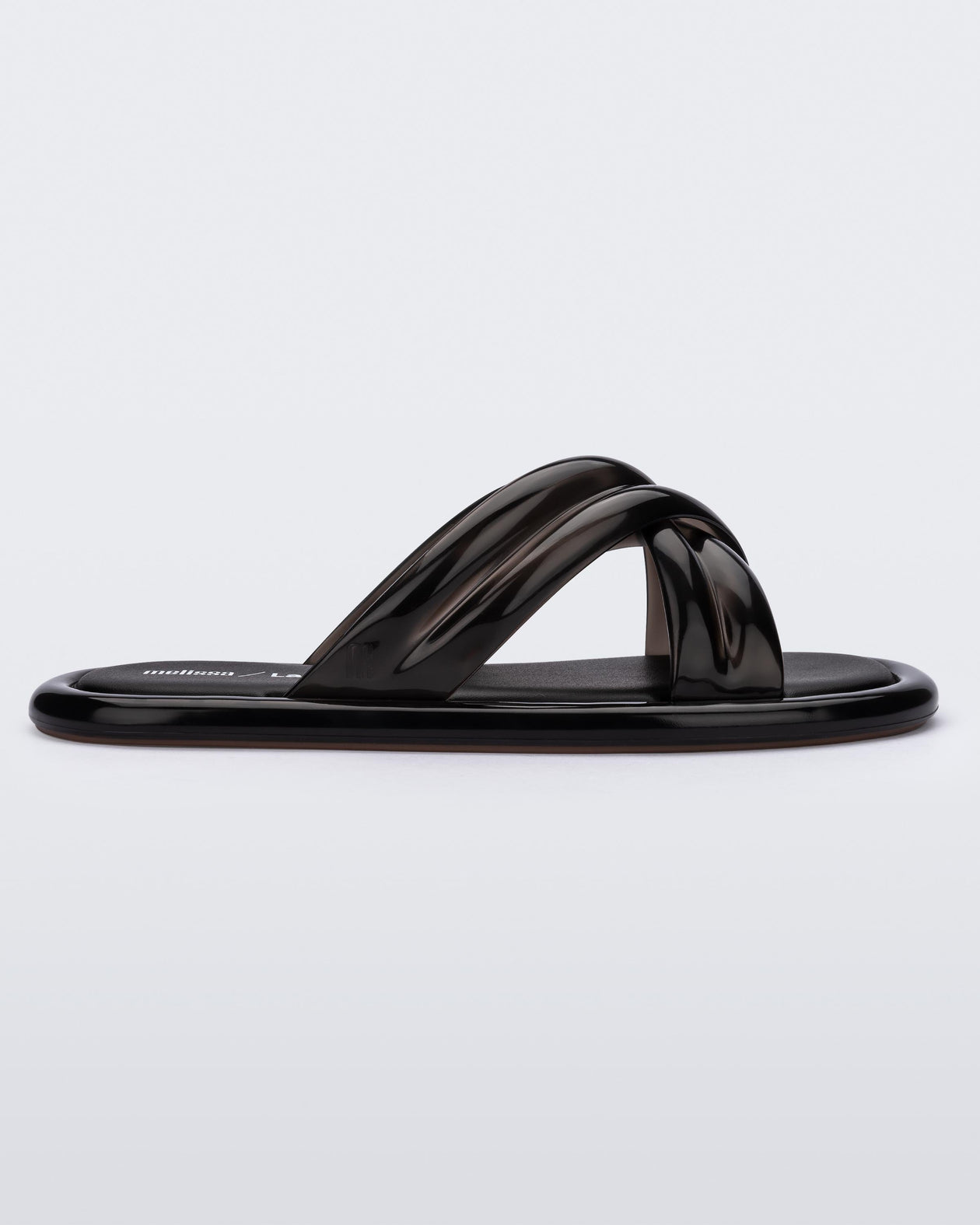 Side view of a black Melissa Cali slide with cross straps.