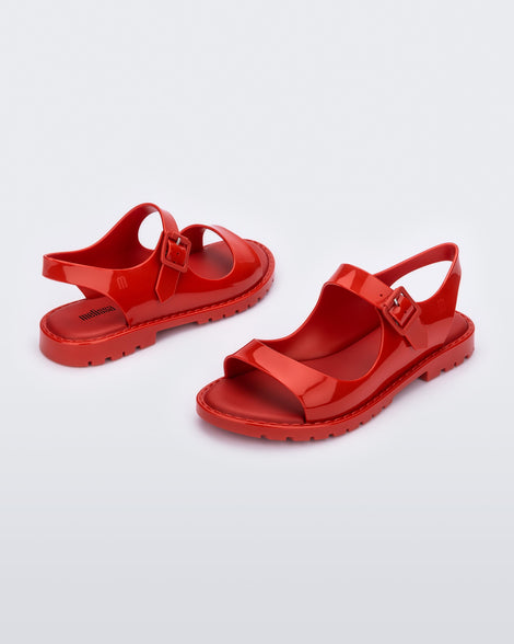 Angled view of a  pair of red Melissa Bae sandals.