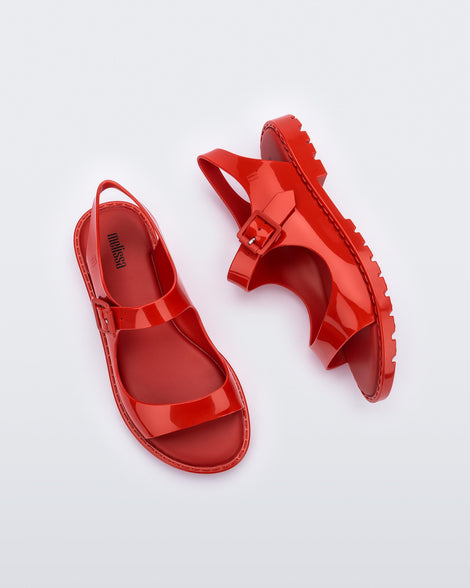 Top and side view of a pair of red Melissa Bae sandals.