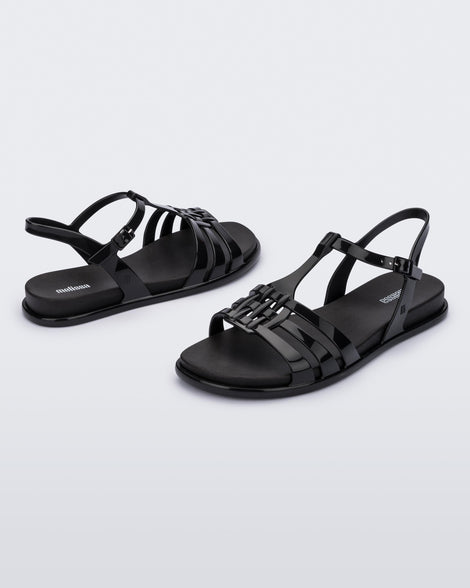 Front and back view of a pair of Melissa Party sandals in black with back ankle strap and buckle closure 