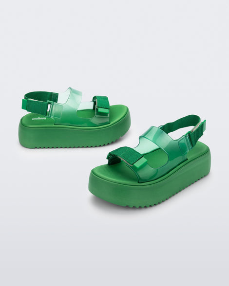 Angled view of a pair of green Melissa Brave Papete platform sandals. 