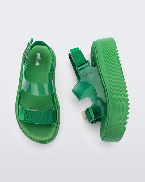 Top and side view of a pair of green Melissa Brave Papete platform sandals. 