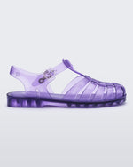 Side view of a transparent lilac Melissa Possession sandal with a closed toe front weft design connected to a top strap with a buckle.