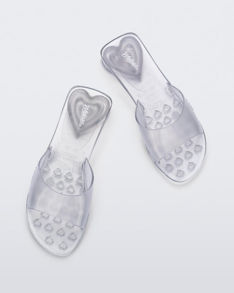 Top view of a pair of transparent clear Melissa Kim slides.