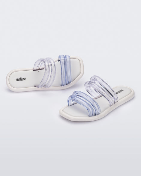 Top and angled view of a pair of white and clear Melissa Airbubble Slides