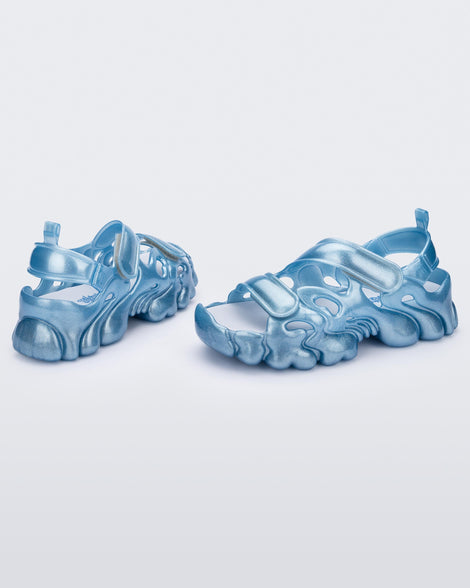 Front and back view of a pair of Melissa Puff chunky sandals in glitter blue with velcro straps