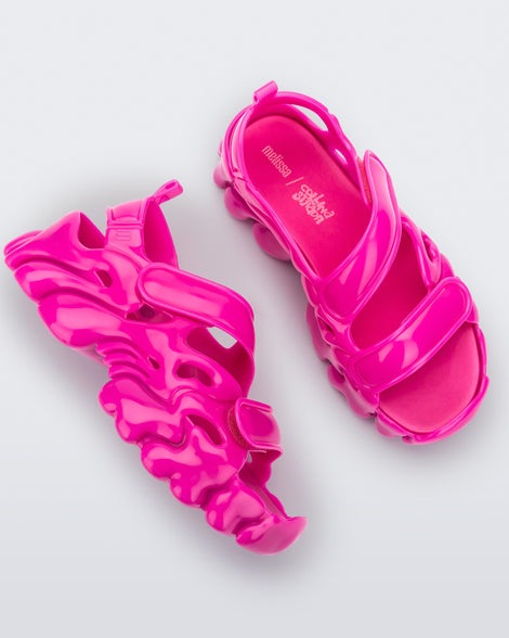 Top and side view of a pair of Melissa Puff chunky sandals in pink with velcro straps