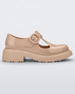 Side view of a beige Mini Melissa Jackie loafer with two cut outs and a buckle detail strap.
