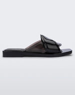 Side view of a black Melissa Brigitte slide with a weft designed upper strap.