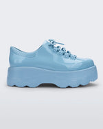 Side view of a blue platform Melissa Kick Off Sneaker with laces.