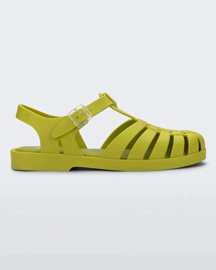 Side view of a moss green Melissa Possession sandal with several straps and a closed toe front.