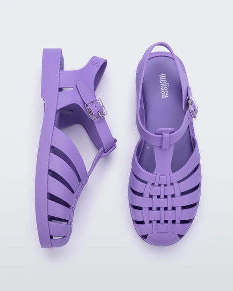 A top and side view of a pair of lilac Melissa Possession sandals with several straps and a closed toe front.