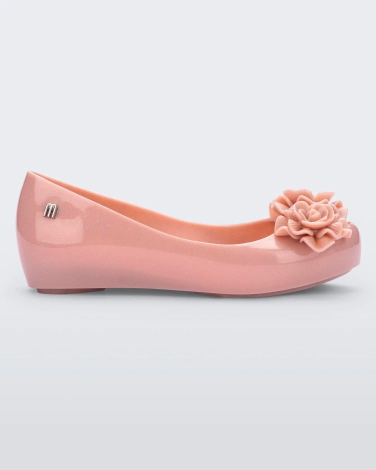 Side view of a light pink Mini Melissa Ultragirl Garden flat with two rose details on the toe.