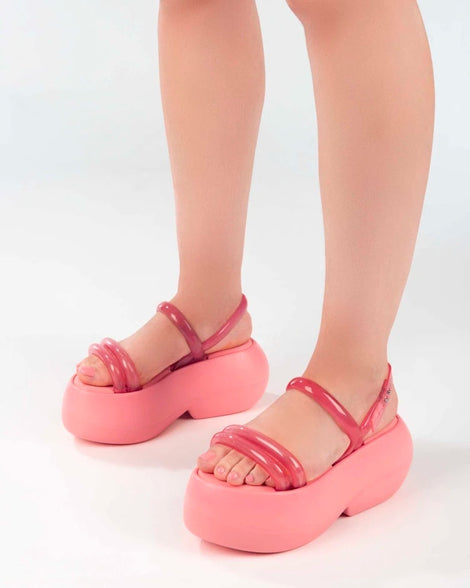 A model's legs wearing pink Melissa Airbubble Platform sandals