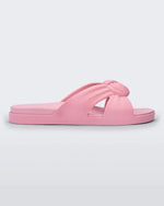 Side view of a pink Melissa Plush slide with a twist front detail.