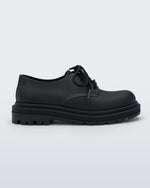 Side view of a matte black Melissa Bass sneaker, with a black base, laces and sole.