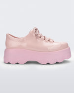 Side view of a pink platform Melissa Kick Off Sneaker with laces.