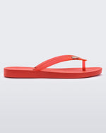 An outter side view of a red Melissa Sun Venice flip flop with a 