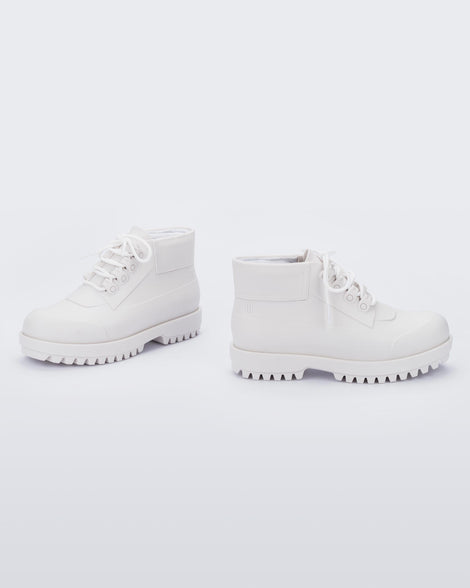 A side view of a pair of matte white Melissa Ares combat boots with a matte white base, laces, top back and sole.