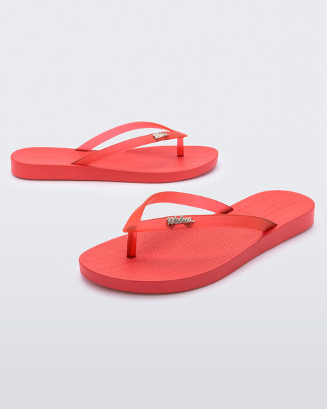 A front and side view of a pair of red Melissa Sun Venice flip flops with a 