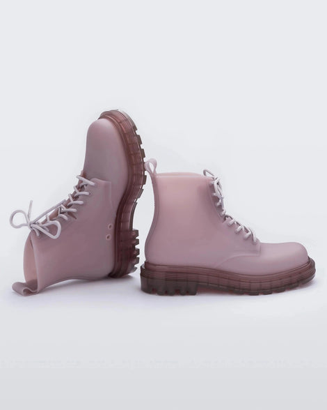 An angled top and side view of a pair of matte Beige/ pastel Lilac Melissa Coturno boot with a lilac base, beige laces and lilac sole.