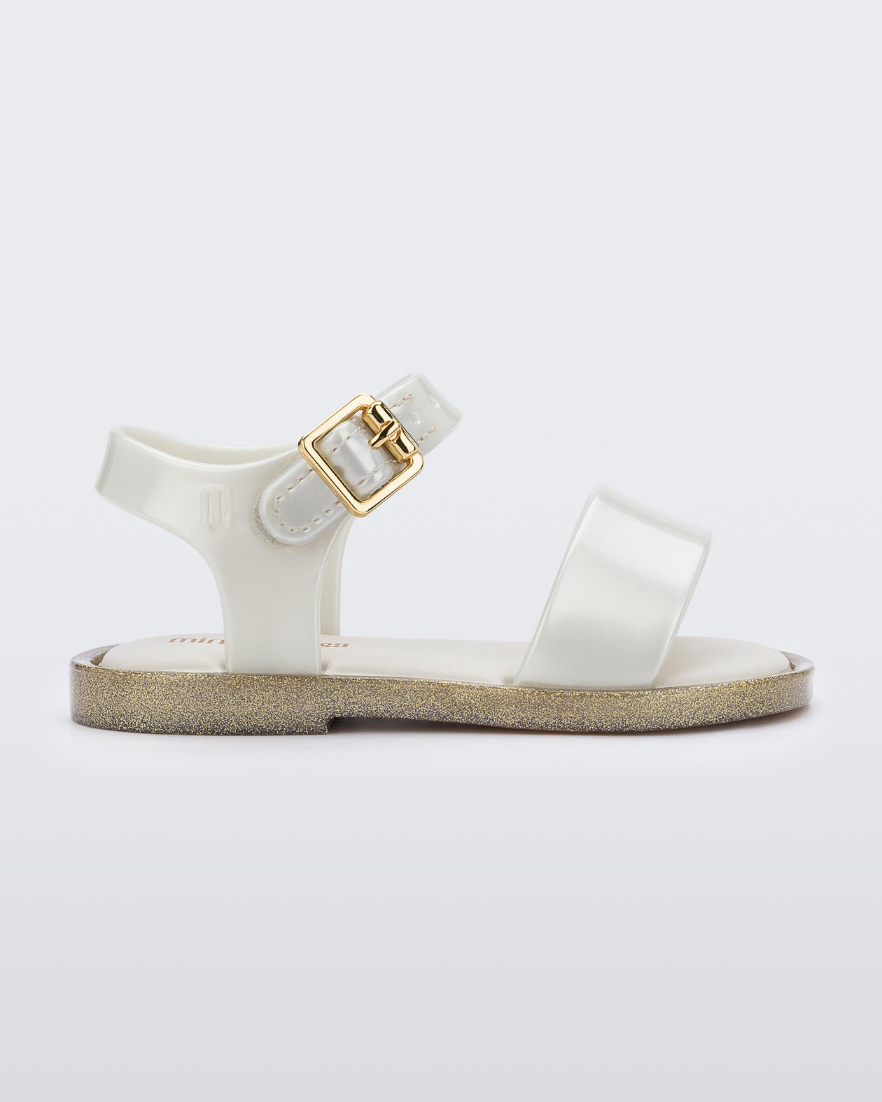 Side view of a white Mini Melissa Mar Sandal with two straps and a gold buckle.