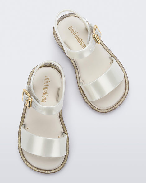 Top view of a pair of white Mini Melissa Mar Sandals with two straps and a gold buckle.